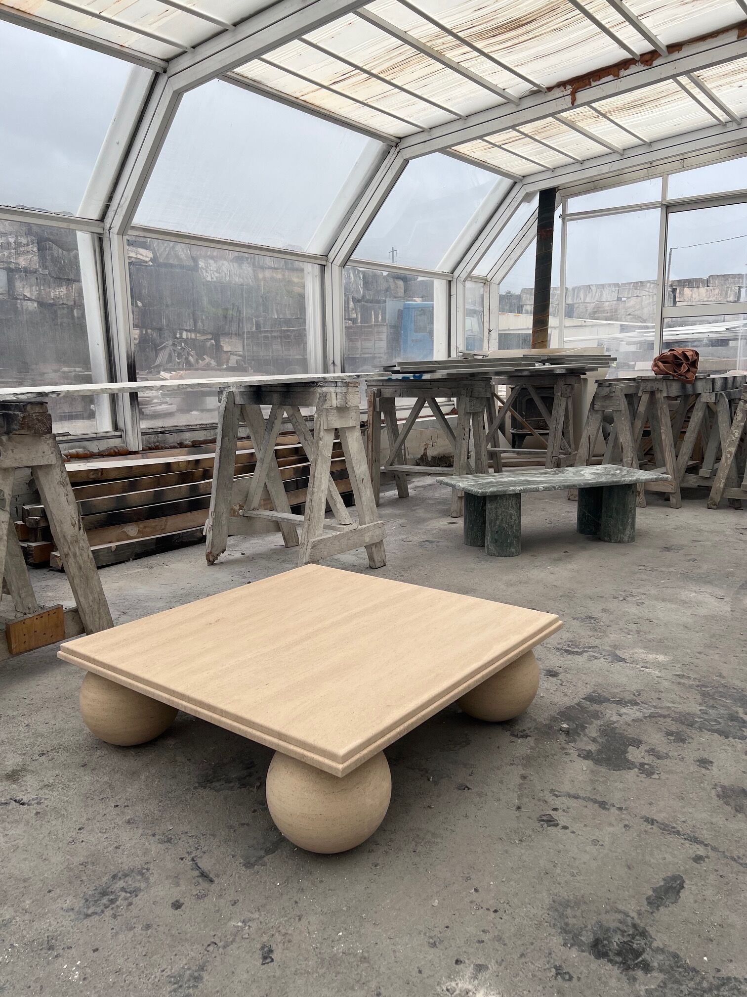 Square stone coffee table with sculptural ball legs