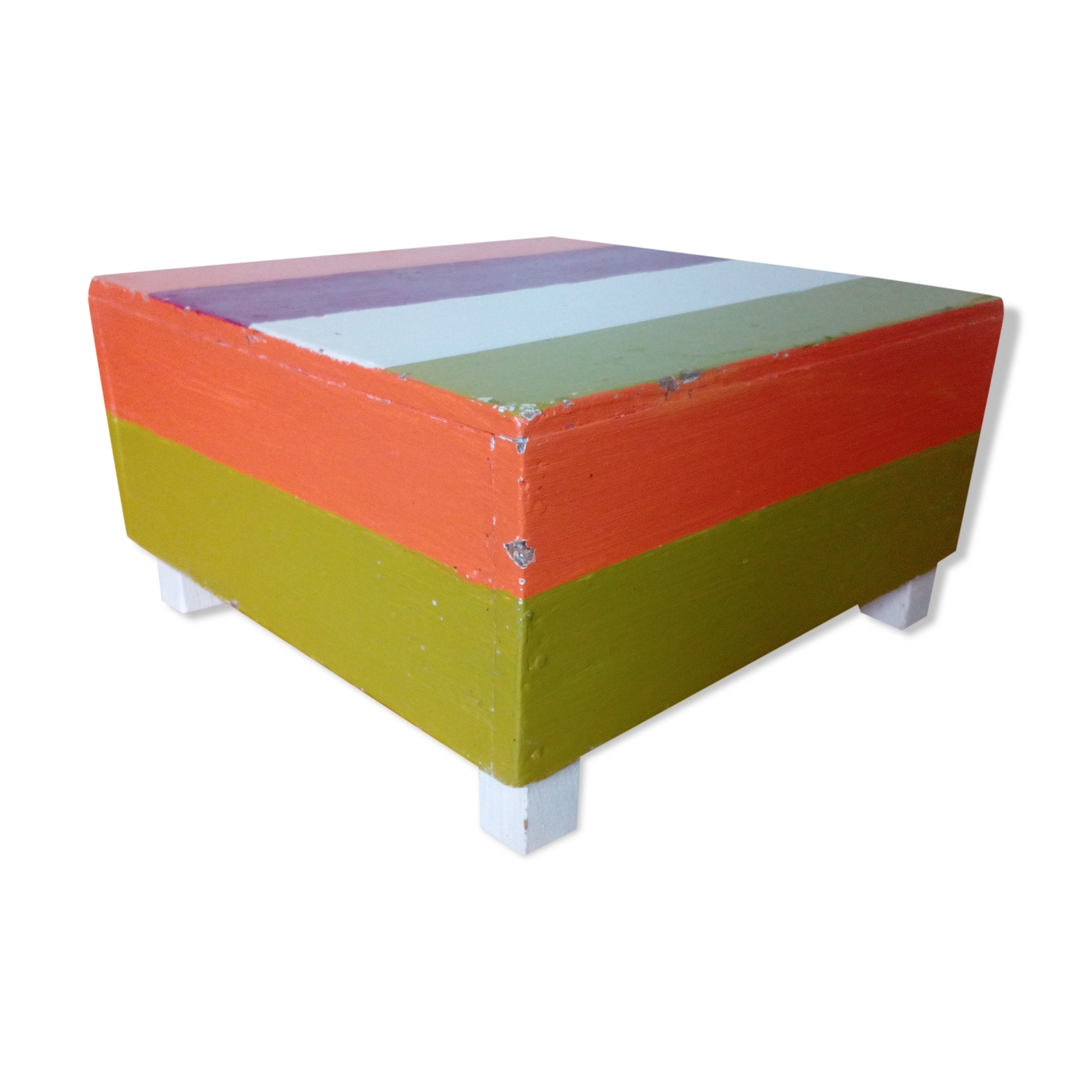Low wooden stool painted in bright colours