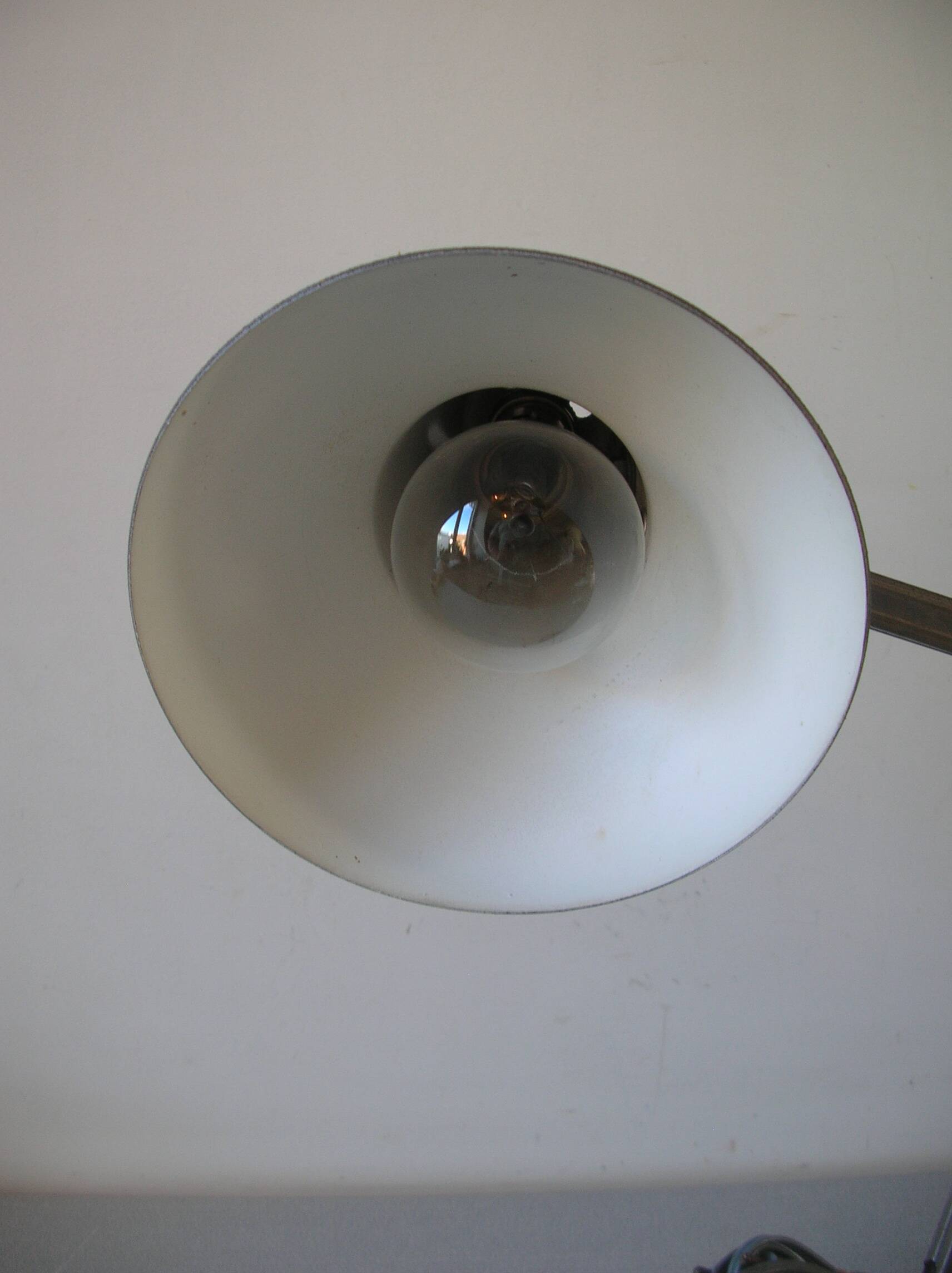 Super Chrome old articulated metal desk lamp on workshop decor base