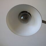 Super Chrome old articulated metal desk lamp on workshop decor base