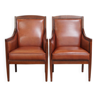 Ensemble majestueux et luxueux de 2 fauteuils design Art Déco en cuir de vachette couleur cognac