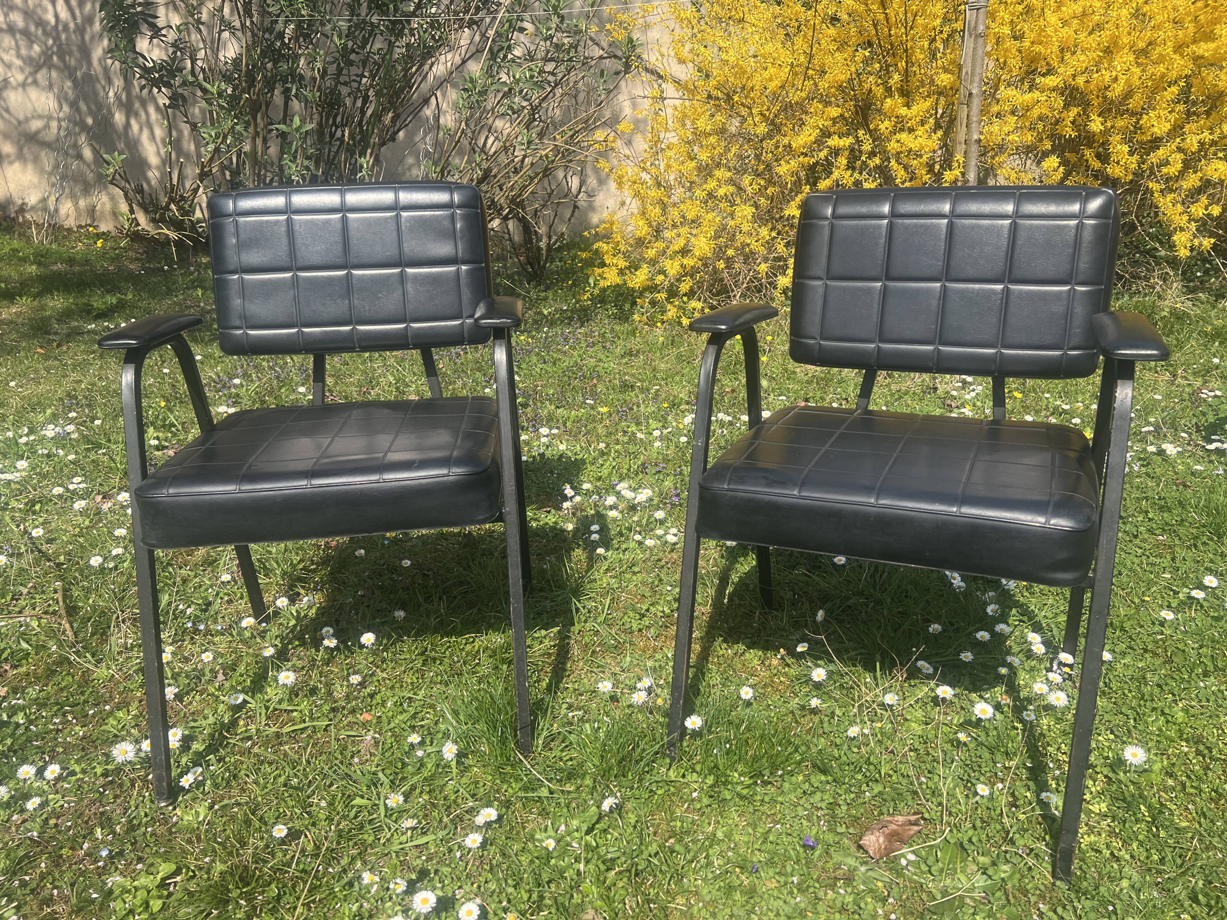 Pair of vintage industrial armchairs in black imitation leather and metal legs