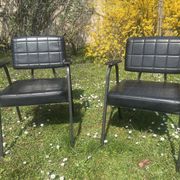Pair of vintage industrial armchairs in black imitation leather and metal legs