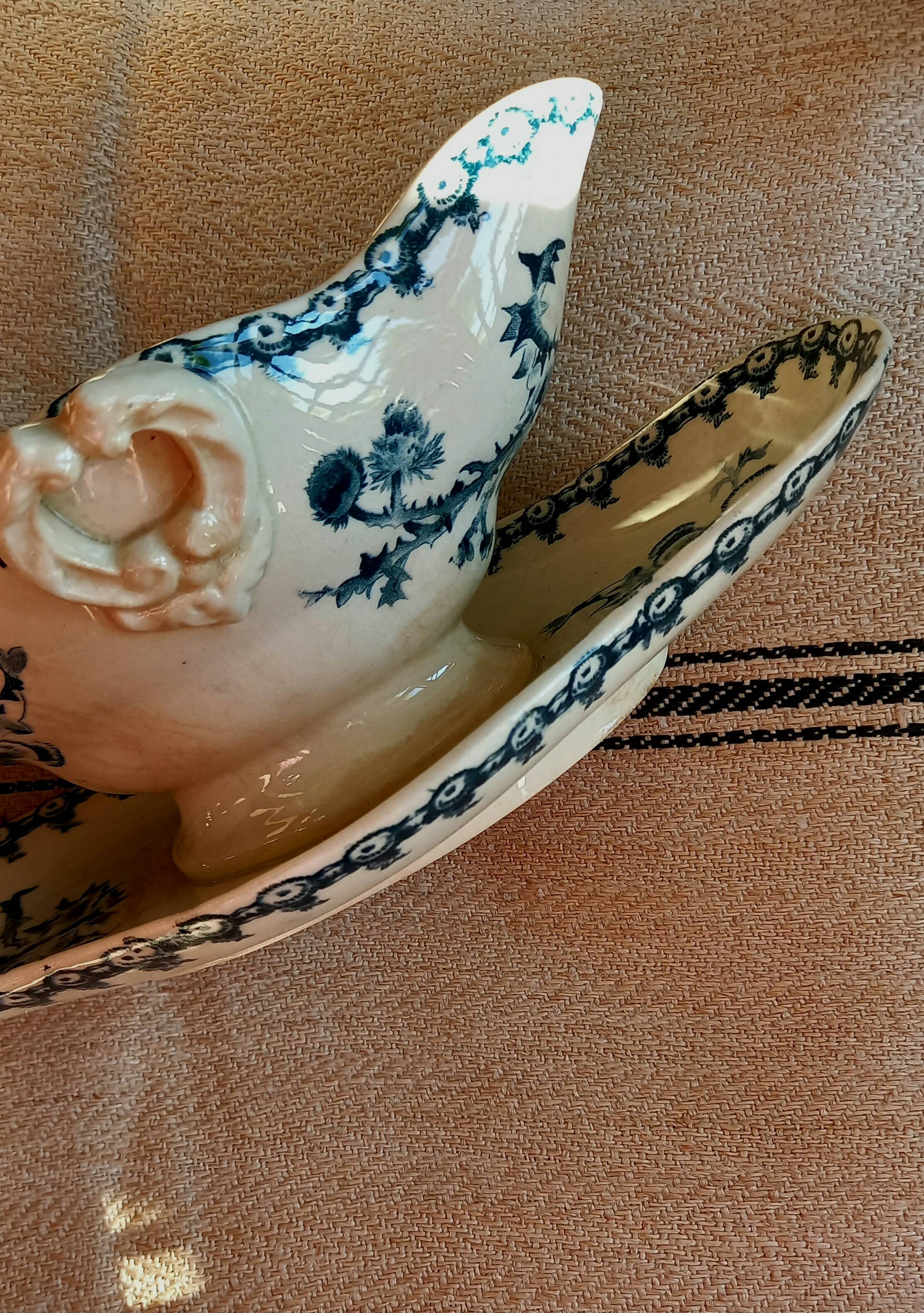 Old gravy boat on frame in terre de fer earthenware by gien, “chardons” model in blue-green