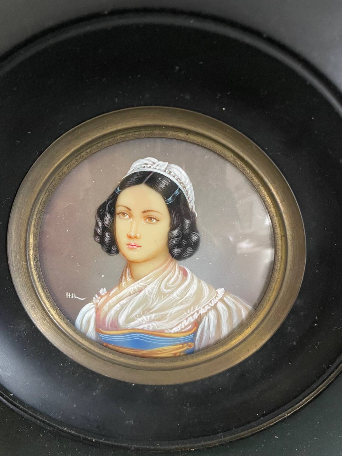 Old miniature portrait painting of a woman.
