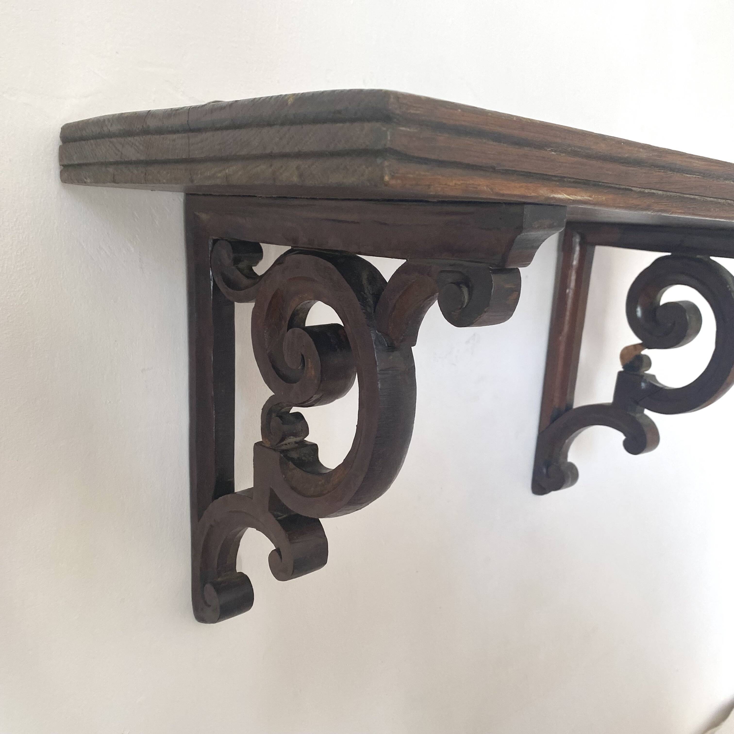 antique oak wall shelf with carved brackets