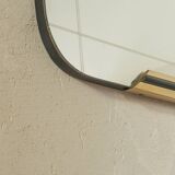 Classic 1950s mirror in black lacquered wooden frame with two brass elements