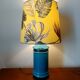 Blue ceramic lamp with claw feet and foliage lampshade.