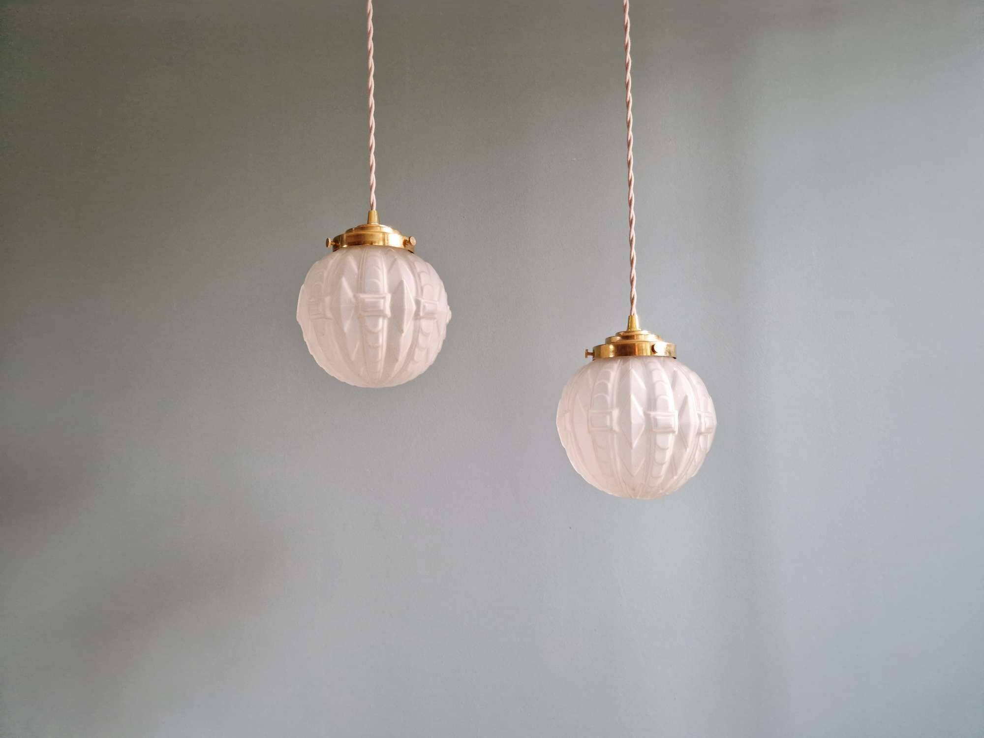 Pair of Art Deco pendant lights in pressed molded satin glass, 1920-30