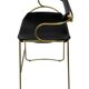 Bar stool with a vintage brass backrest and black leather.