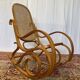 Antique rocking chair in curved wood and caning.