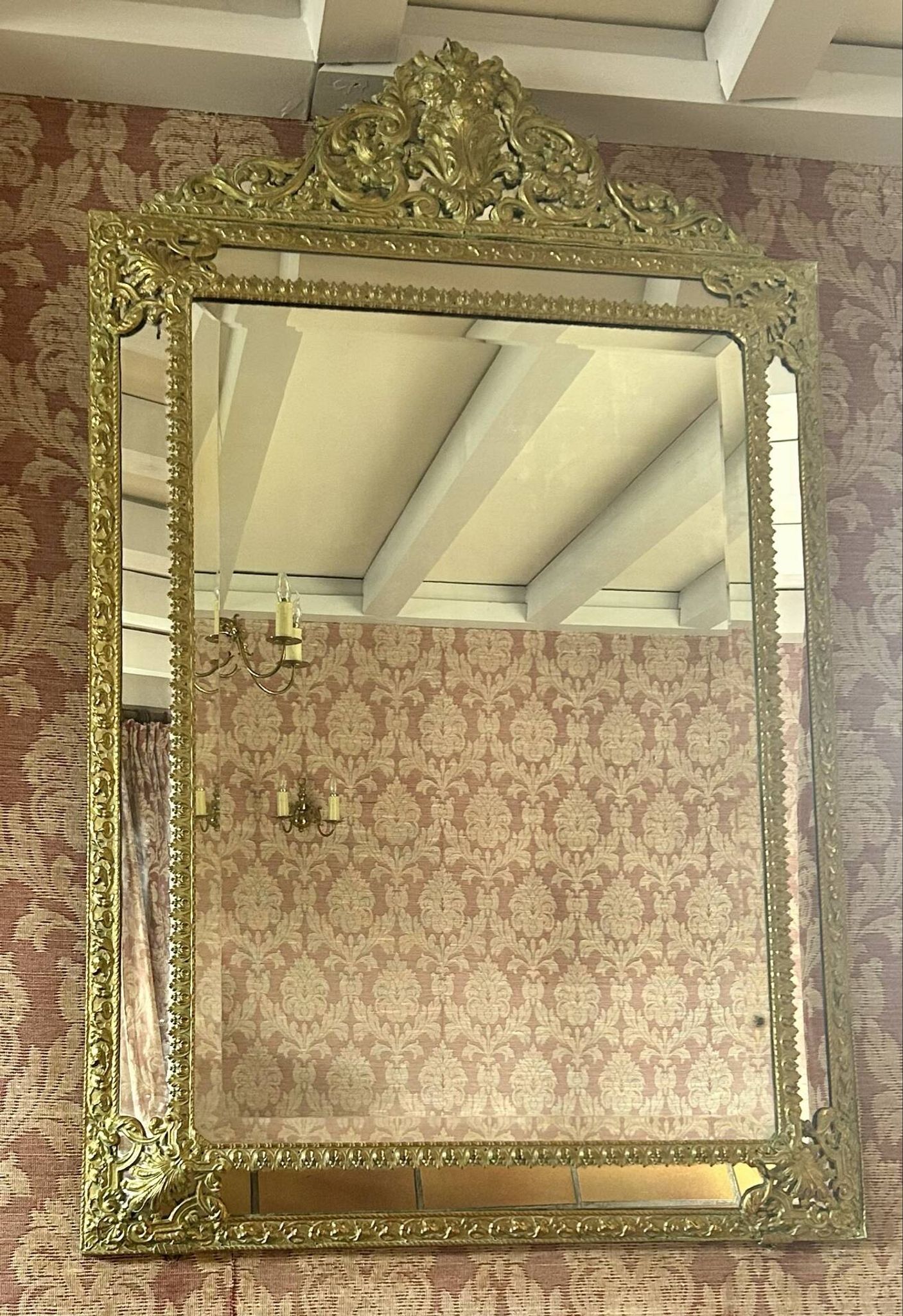 A wall mirror in the Louis XVIII style.