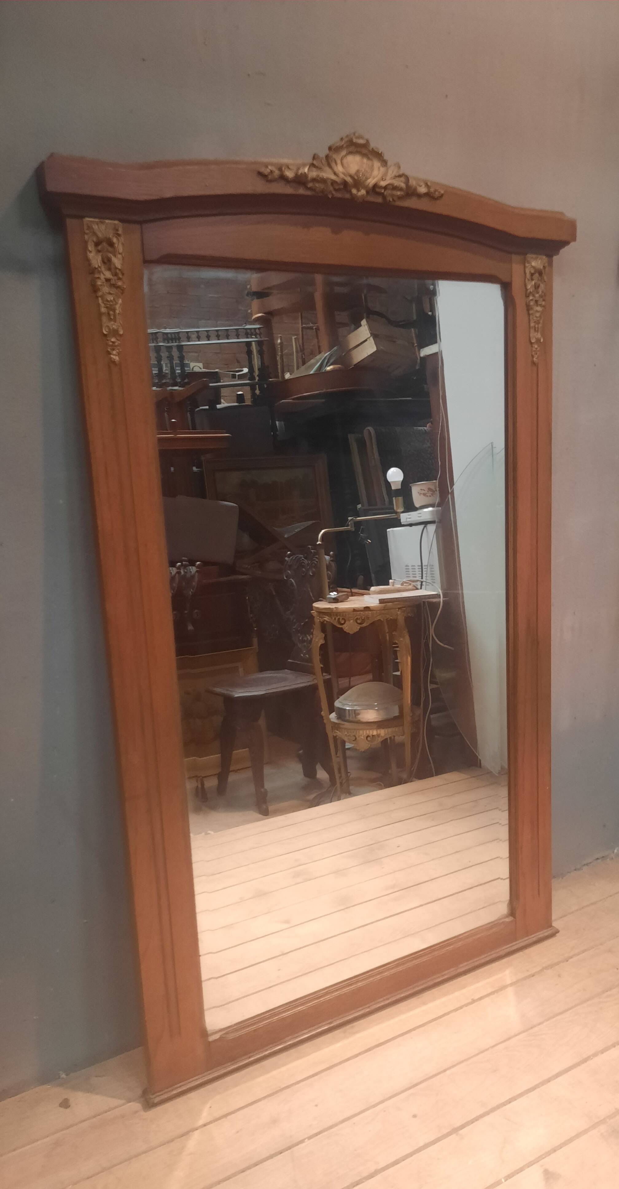 Bevelled mirror surrounded by a wooden frame.