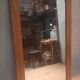 Bevelled mirror surrounded by a wooden frame.