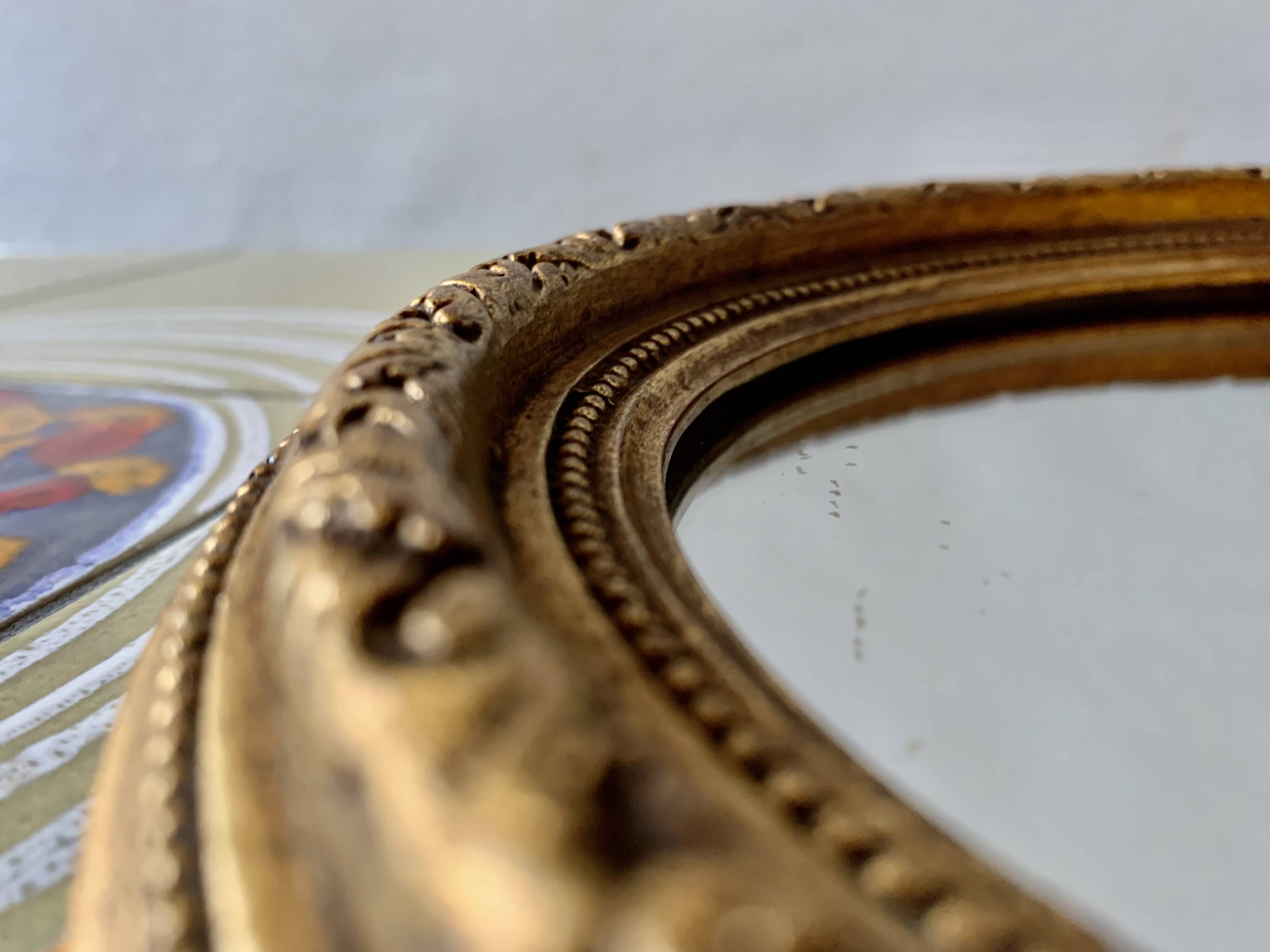 Small vintage wall mirror in gold painted wood