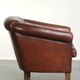 Characterful sheepskin club armchair in a dark cognac colour in English style