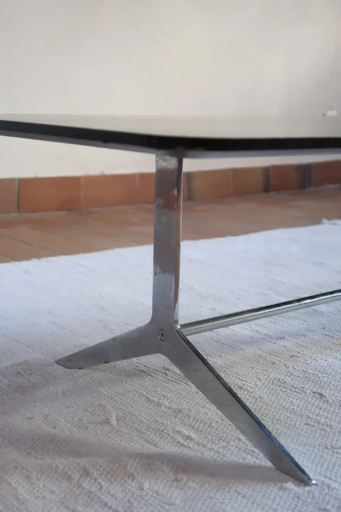 70s design coffee table with a black top and steel legs.