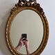 Louis xvi style oval mirror decorated with ribbons