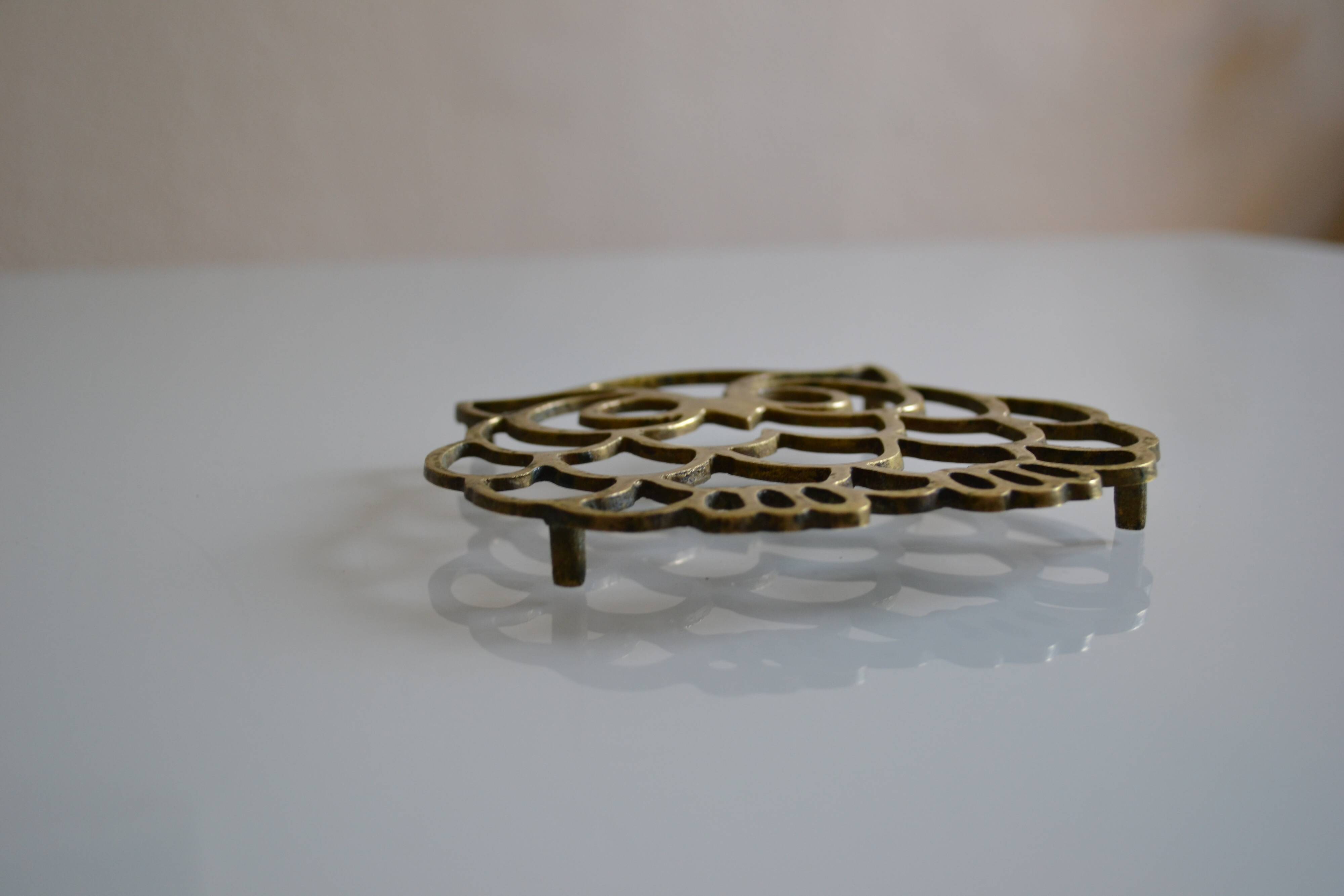 Vintage openwork brass trivet in the shape of an owl or owl