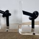 Bookends in plexiglass and knotted black tubes, 1980s design.