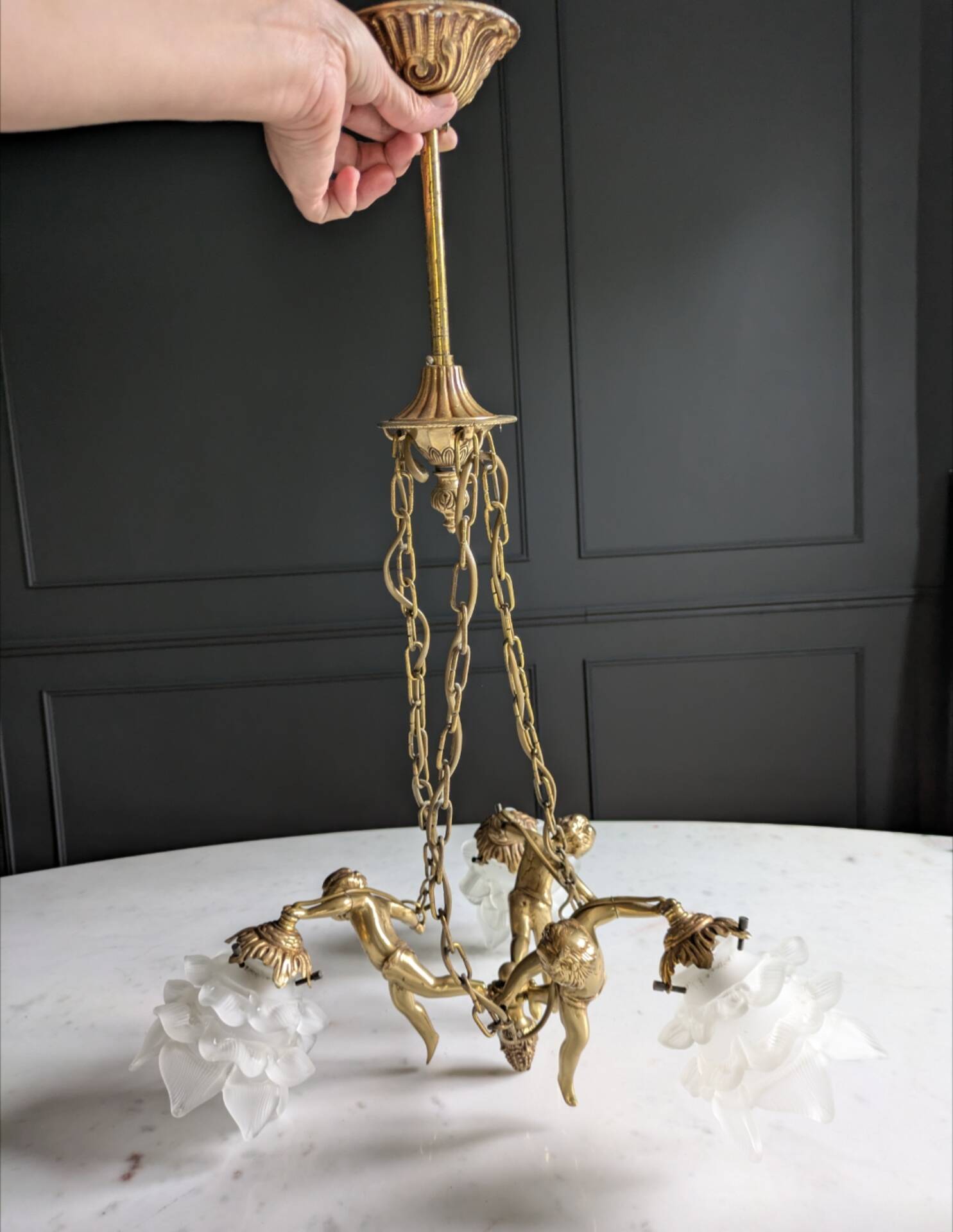 Vintage chandelier with cherubs and frosted glass flowers.