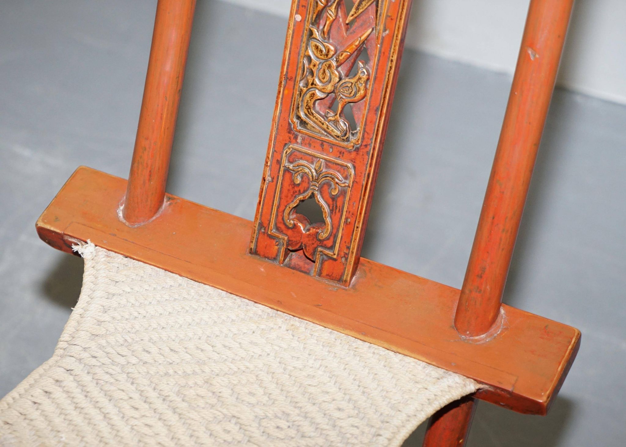 Antique Chinese folding chair with carvings, circa 1900-1920.