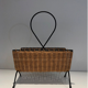Rattan and black lacquered metal magazine rack