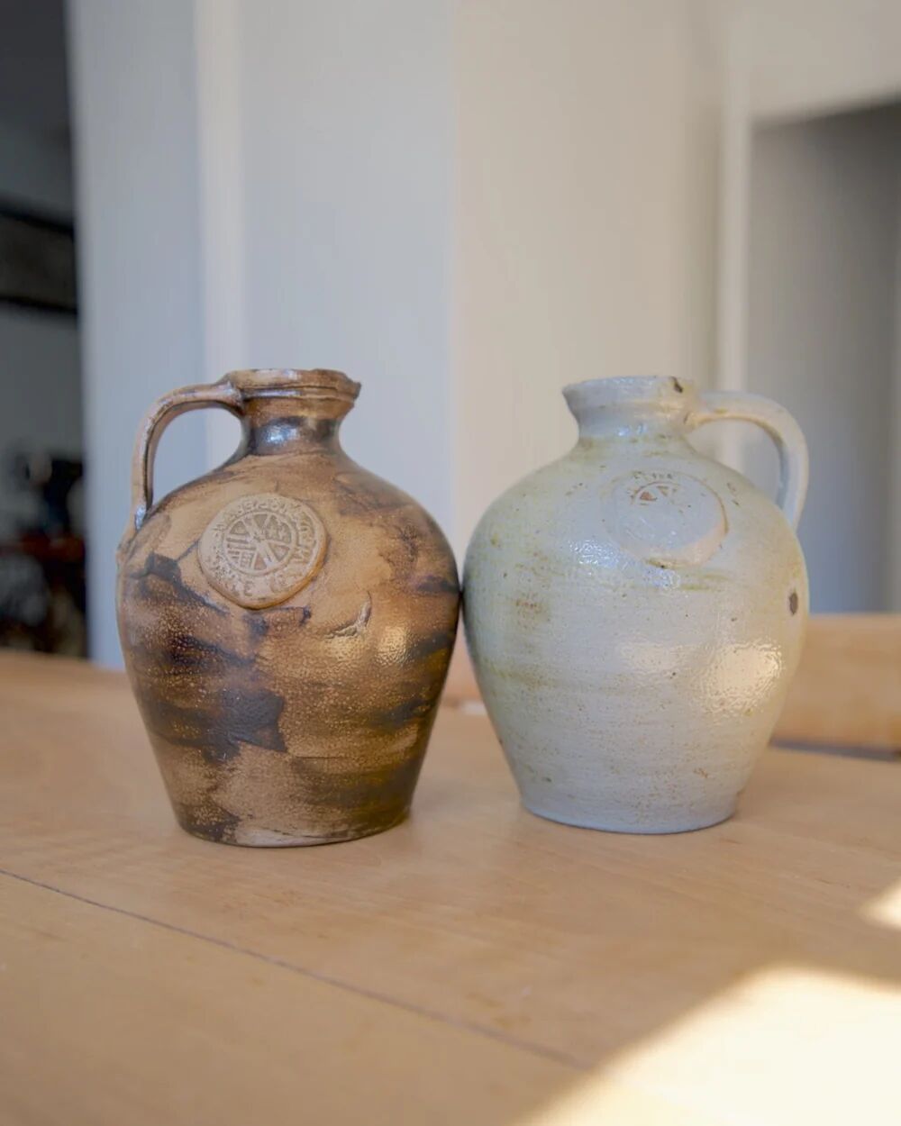 Duo of brown and cream ceramic jugs