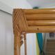 Storage column, wooden bookshelf and woven rattan.