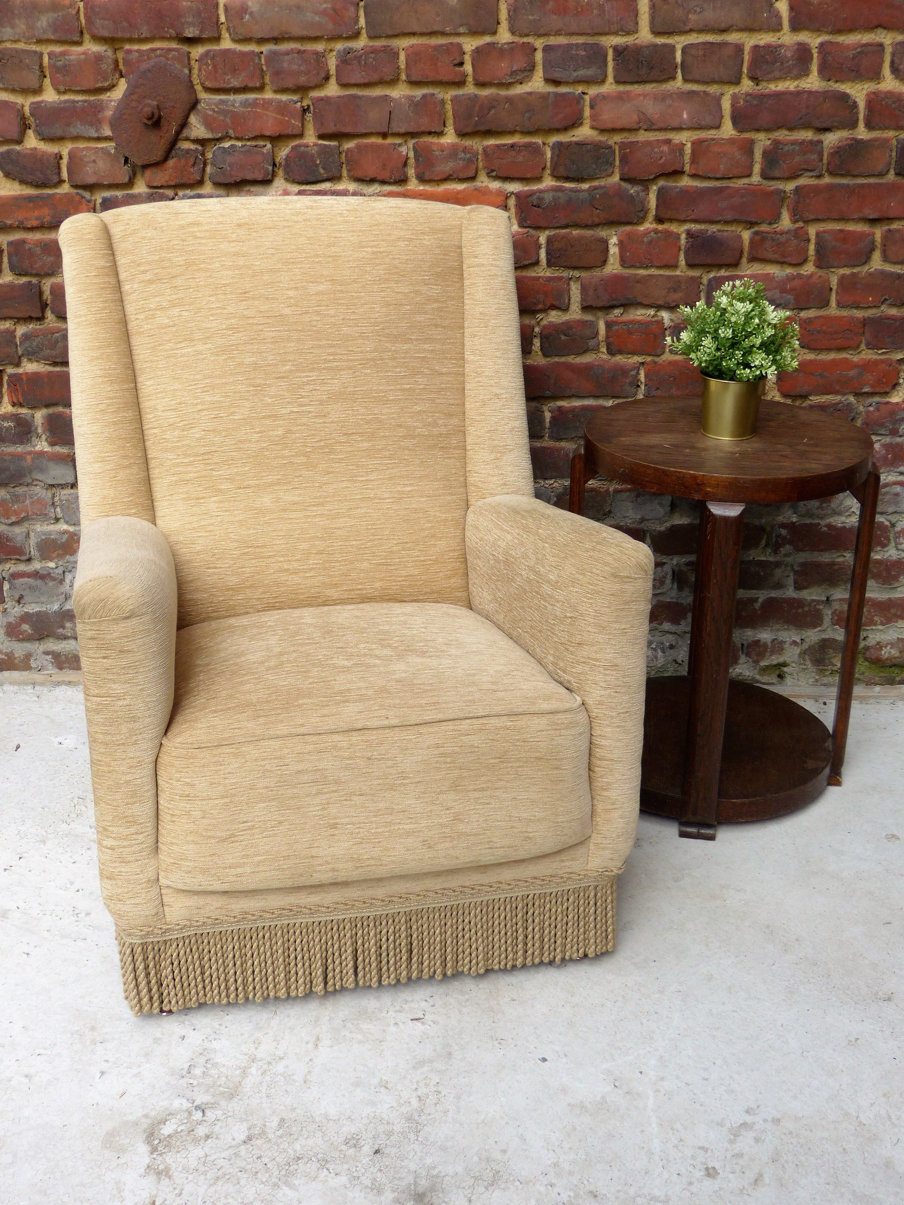 Fauteuil en velour beige et franges