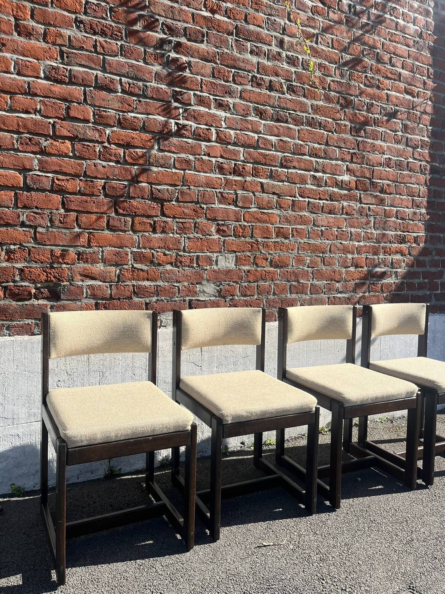 Many mid-century vintage wooden and fabric chairs.