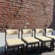 Many mid-century vintage wooden and fabric chairs.