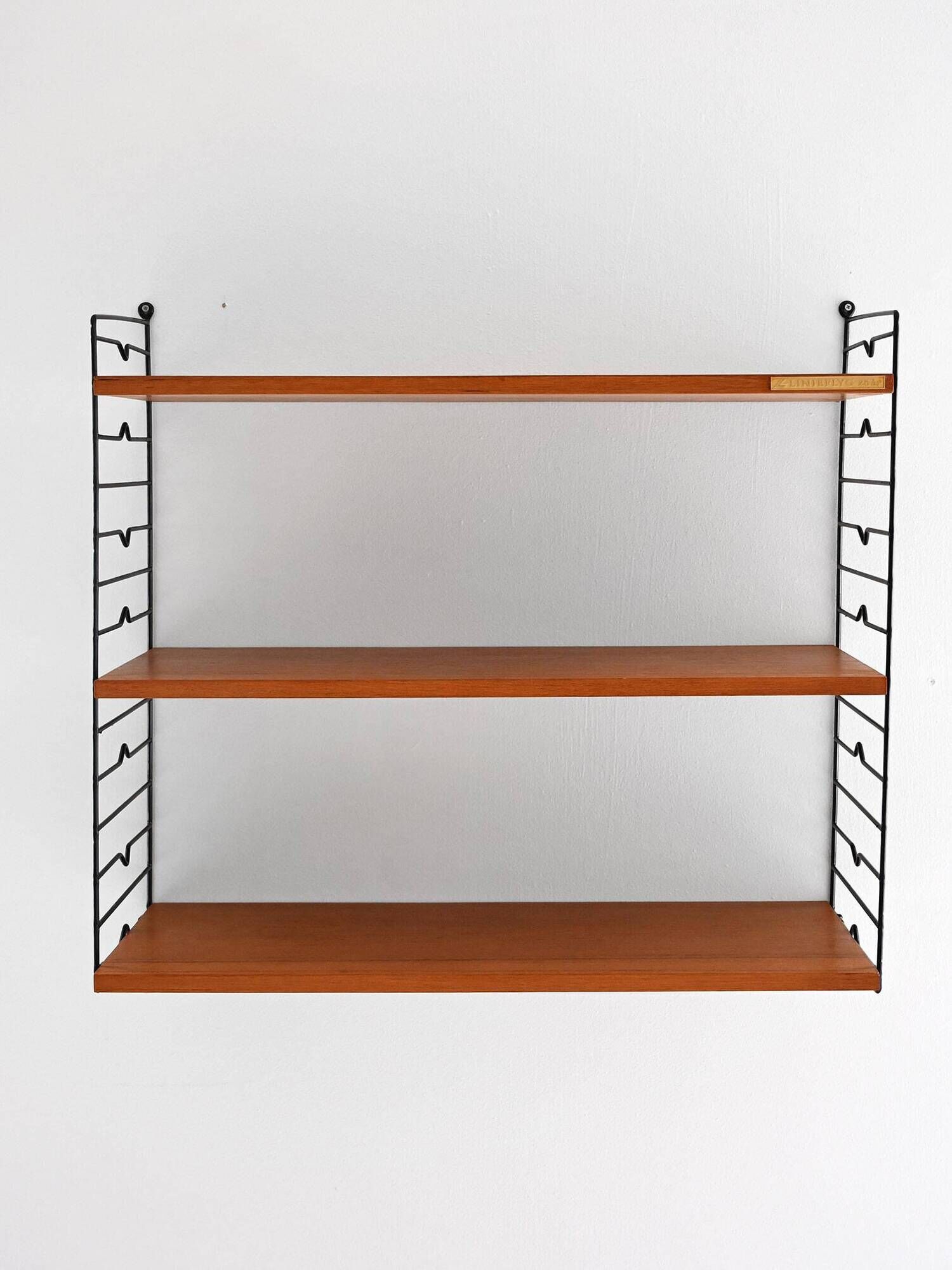 Scandinavian Hylla teak wall shelf with brass label