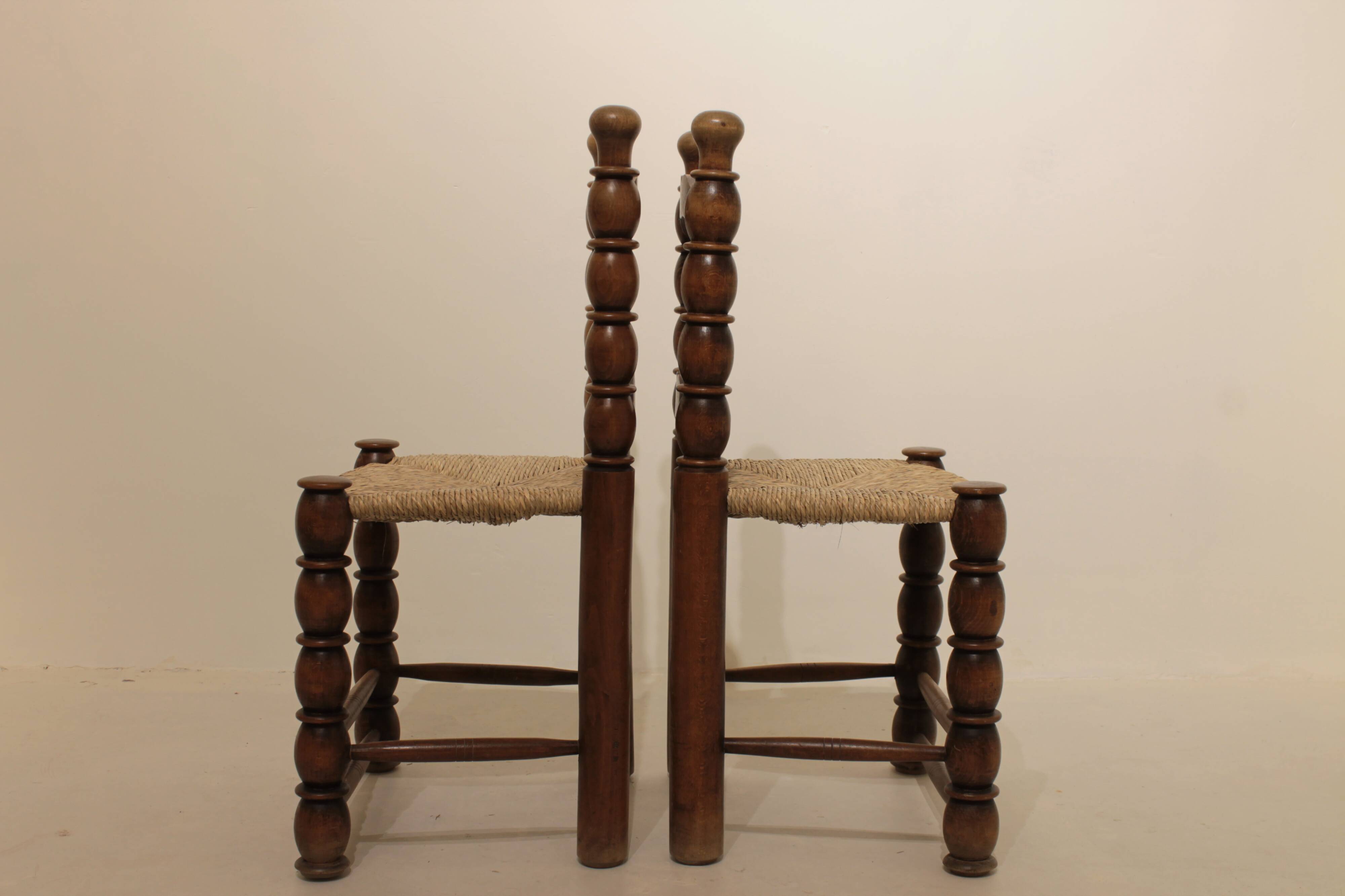 Pair of rustic chairs in turned wood with straw seats