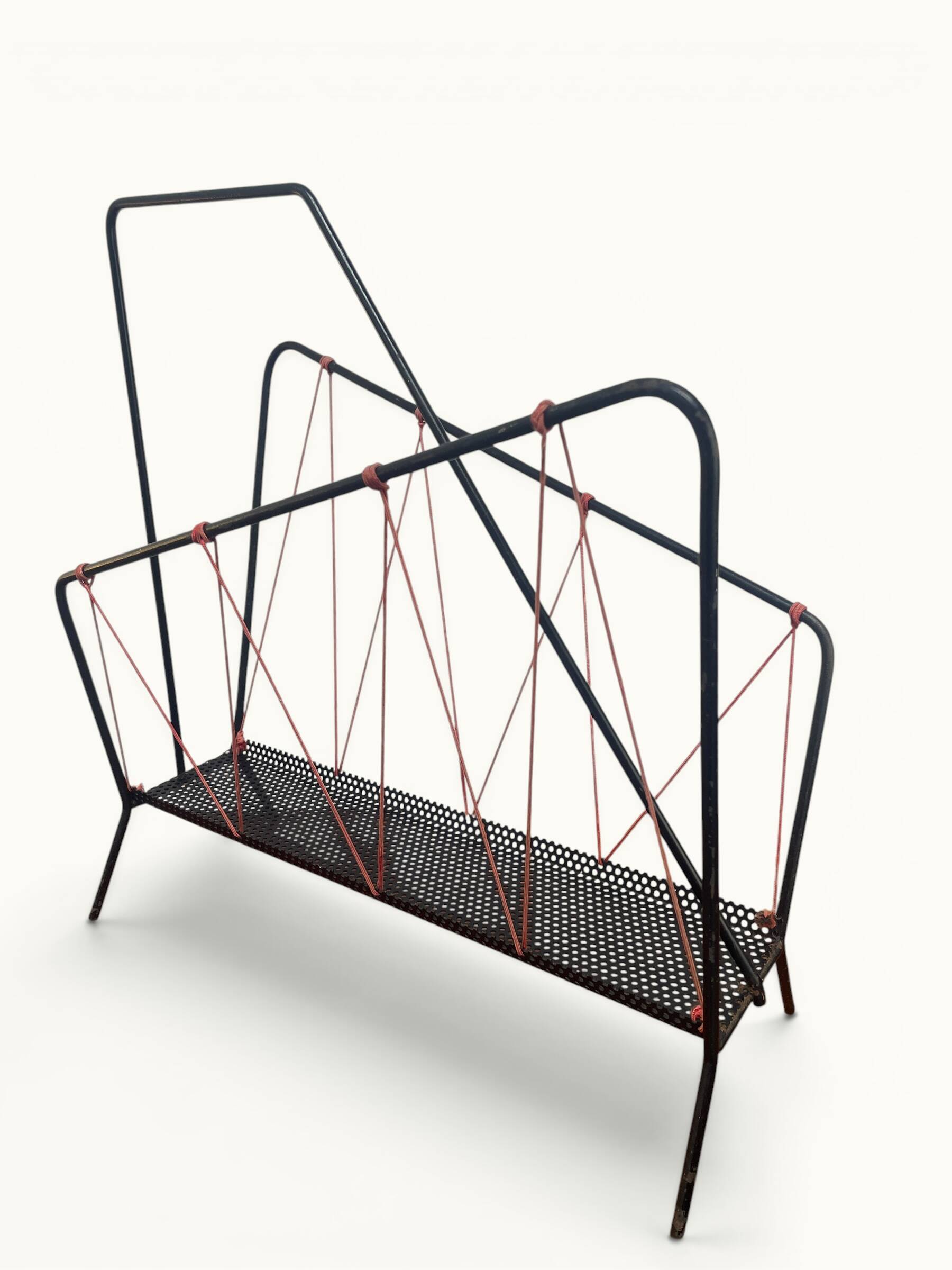 Vintage perforated metal magazine rack with cord handles by Matégot from the 1950s-60s.