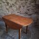 Rustic French antique dining table, drop-leaf table in cherry wood, circa 1900.