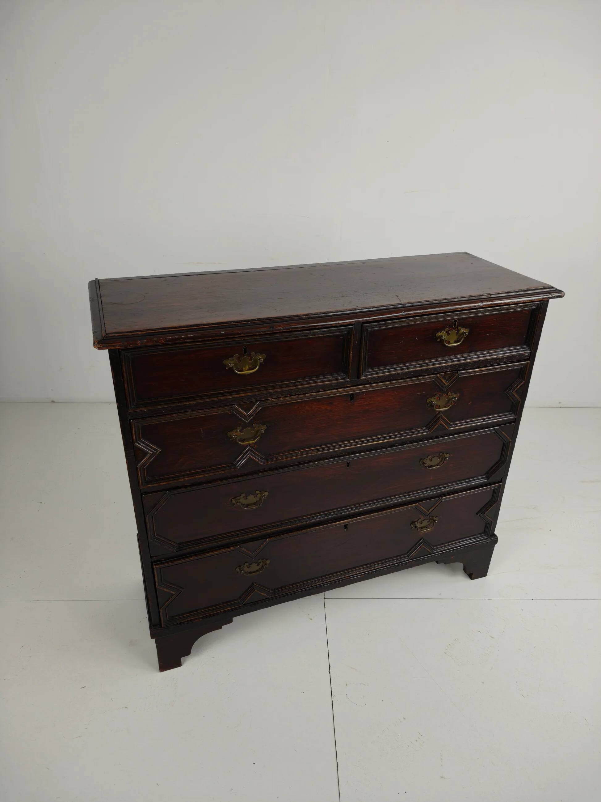 English geometric-panelled oak chest of drawers, circa 1680