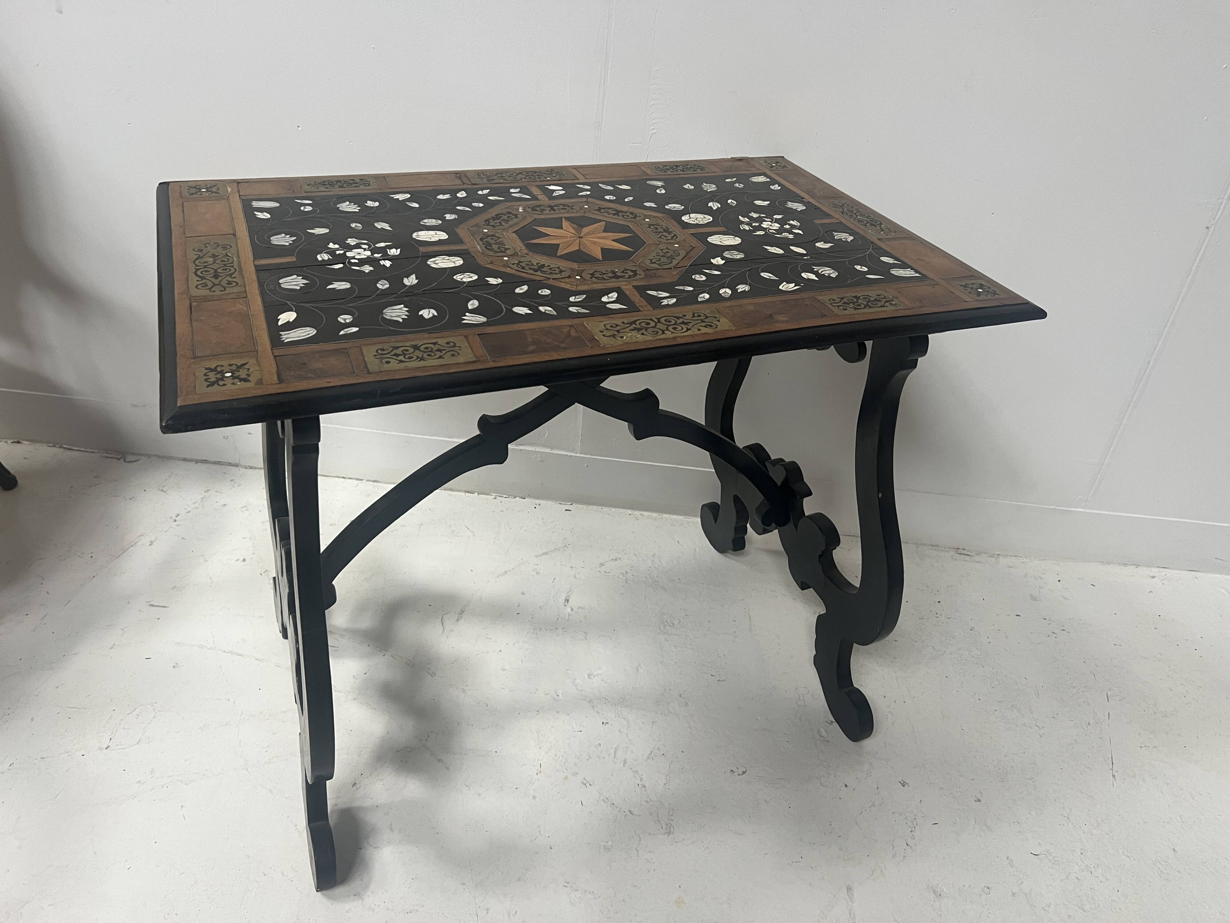 Blackened wood display table with marquetry top, Spain, 19th century.
