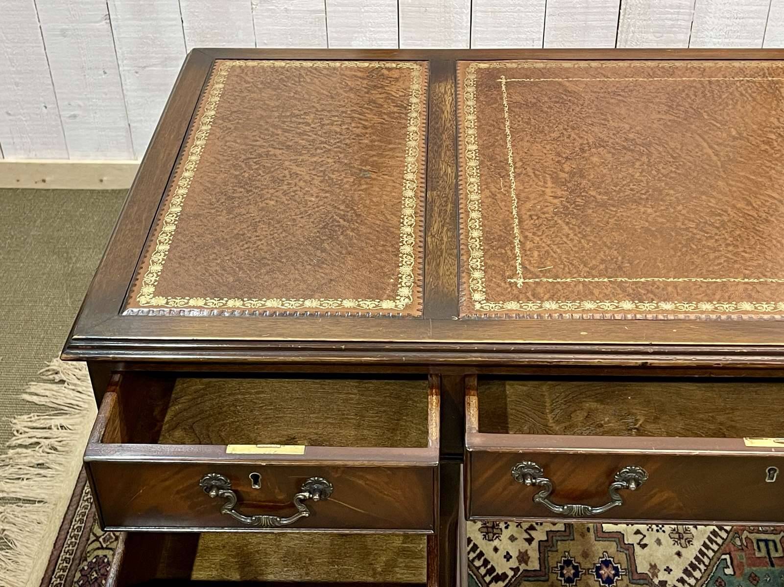 English mahogany pedestal desk with leather top from the 1950s