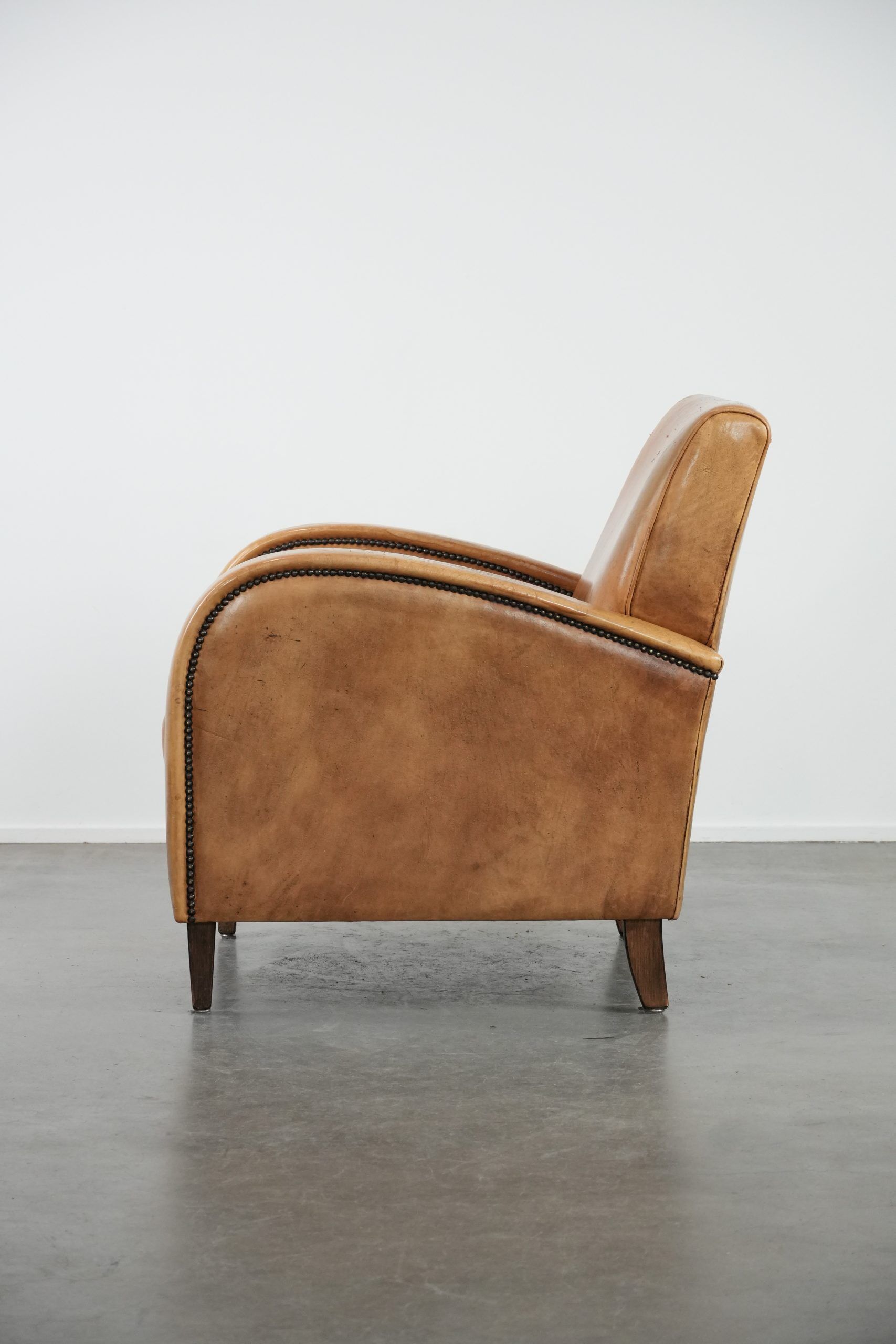 Luxury armchair made of cowhide leather with a beautiful warm colour scheme