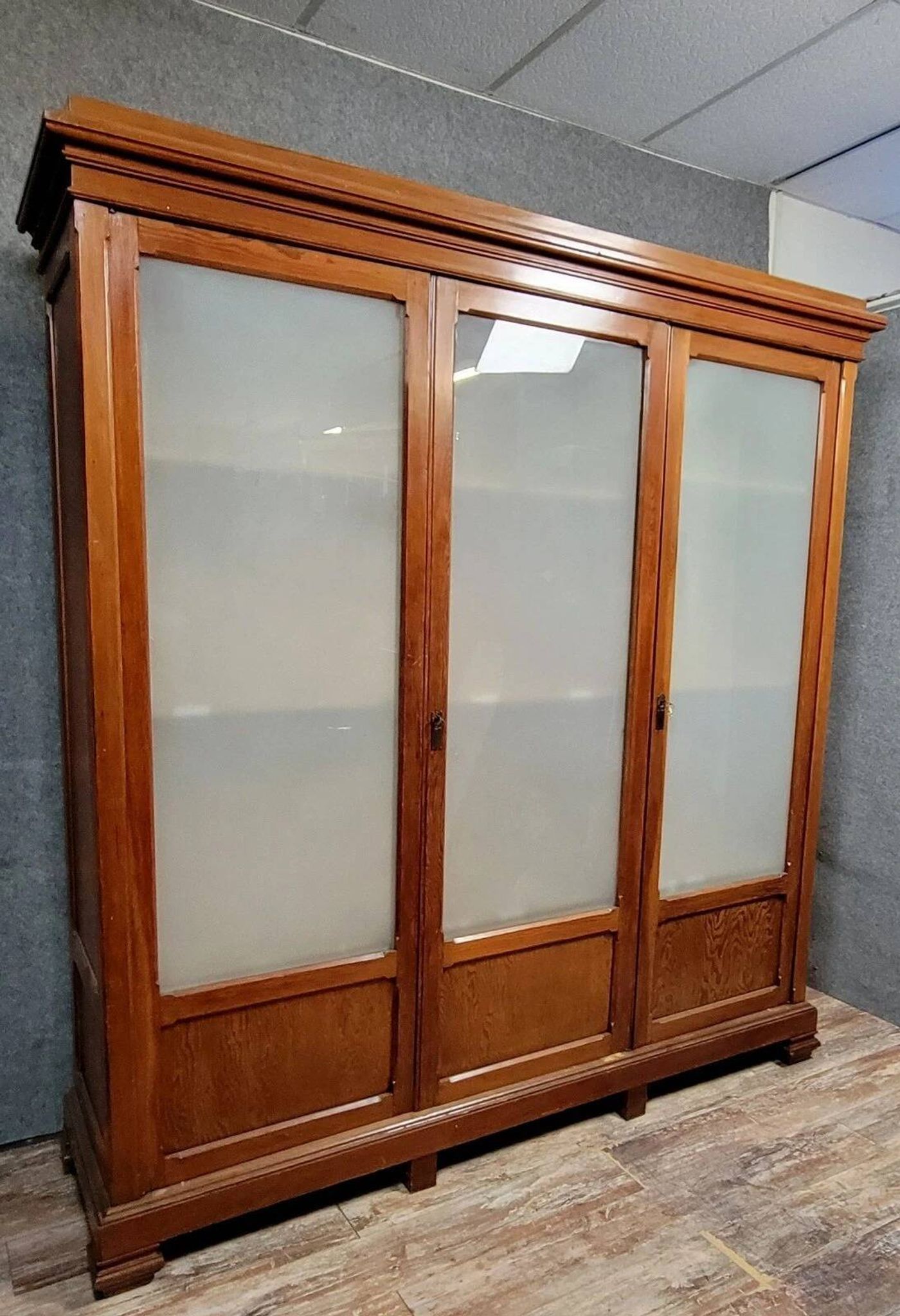 Large pine bookcase with three doors, fitted with frosted glass.