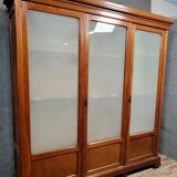Large pine bookcase with three doors, fitted with frosted glass.
