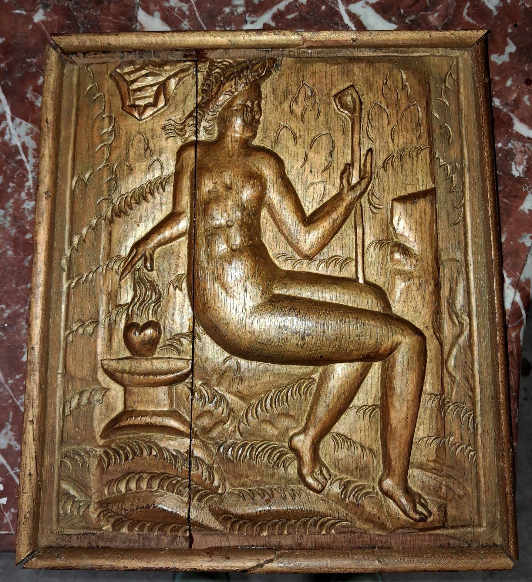 Carved oak panel depicting an allegorical female figure.