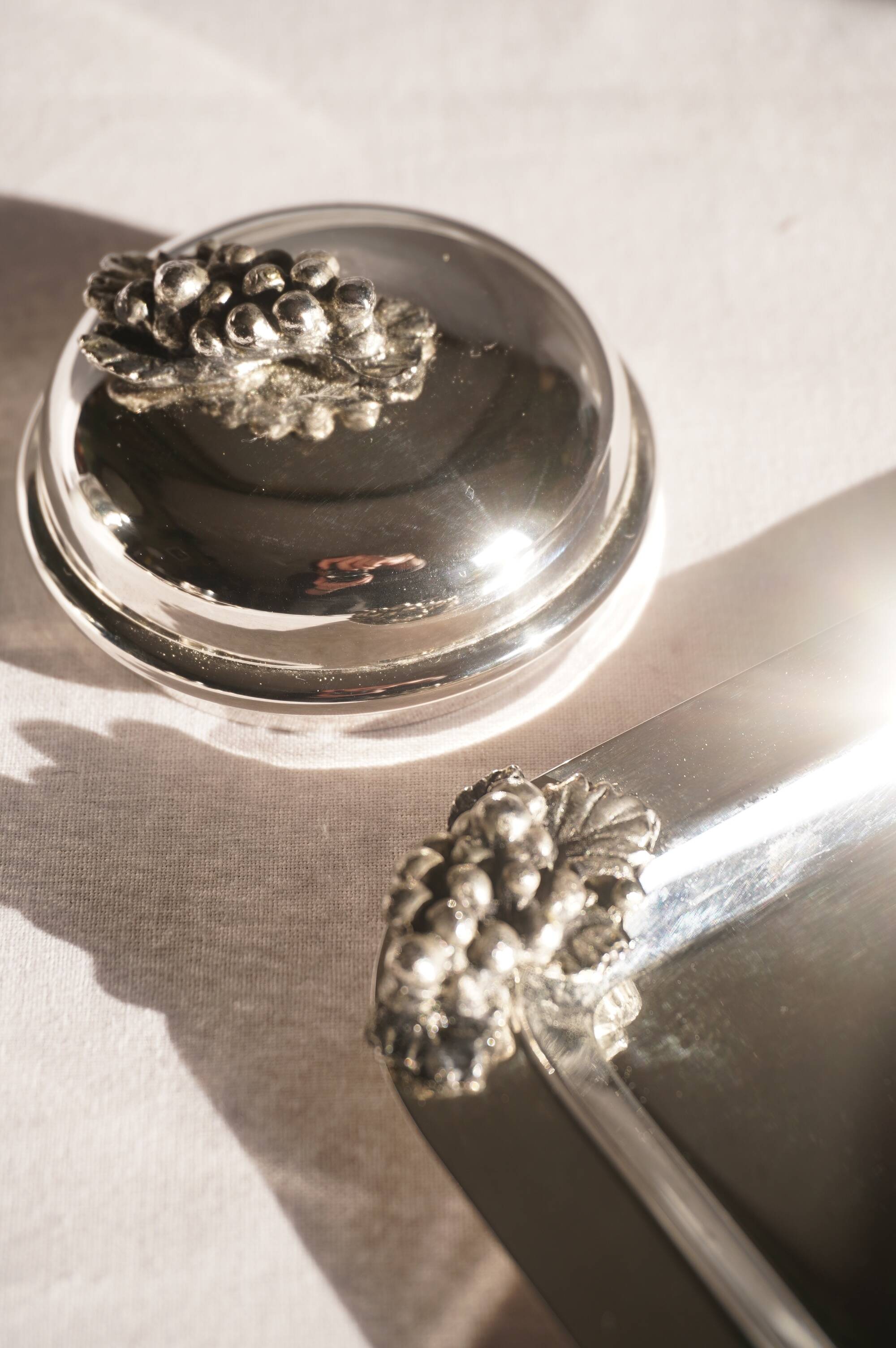 Silver-plated metal coffee service with a grape design.