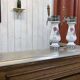 Bar counter in oak, zinc, and white marble from the early 20th century.