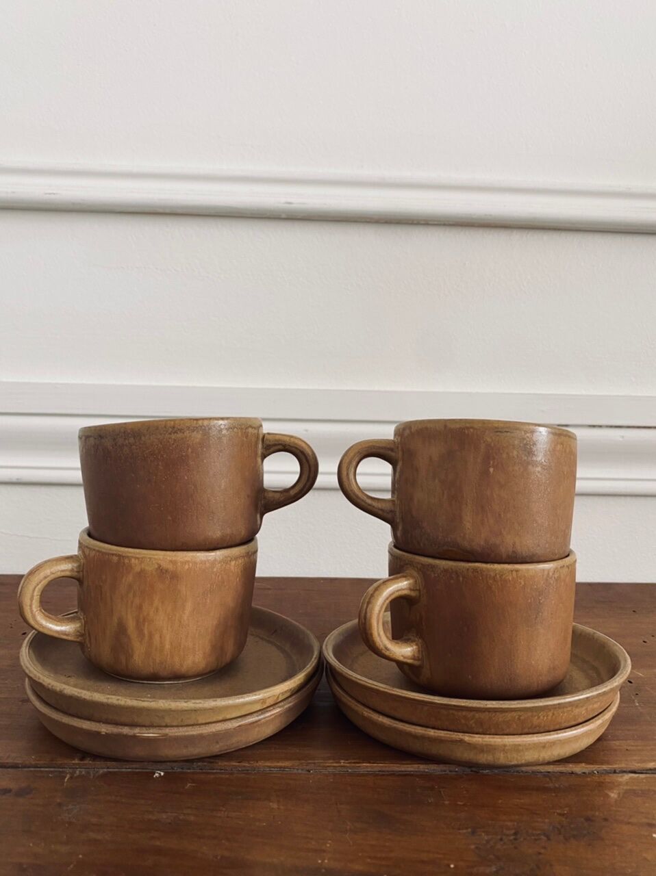 4 stoneware coffee cups and saucers