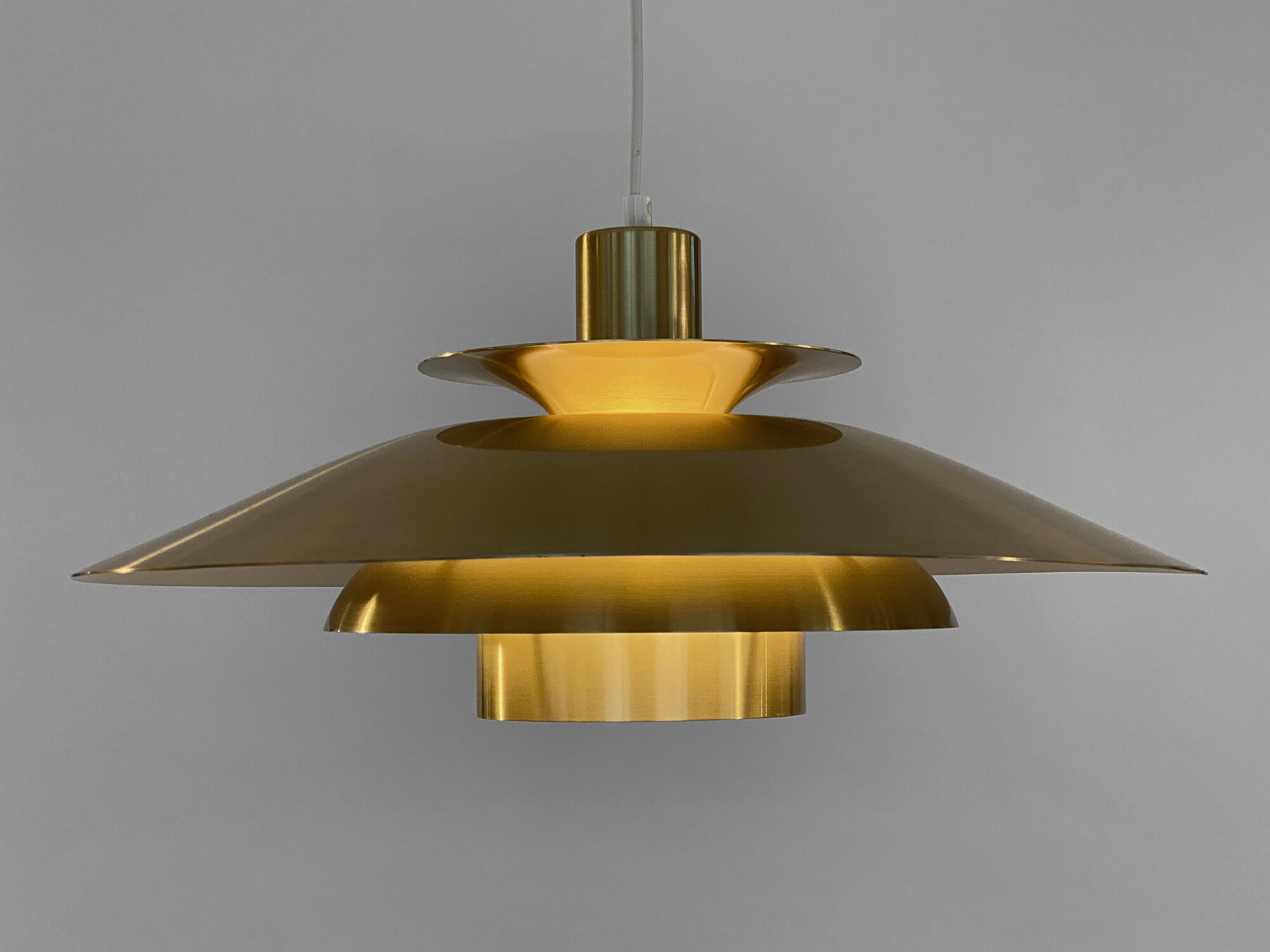 Golden colored aluminum pendant light from Frandsen Lighting. Denmark 1970s