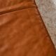 Ottoman with leather upholstery