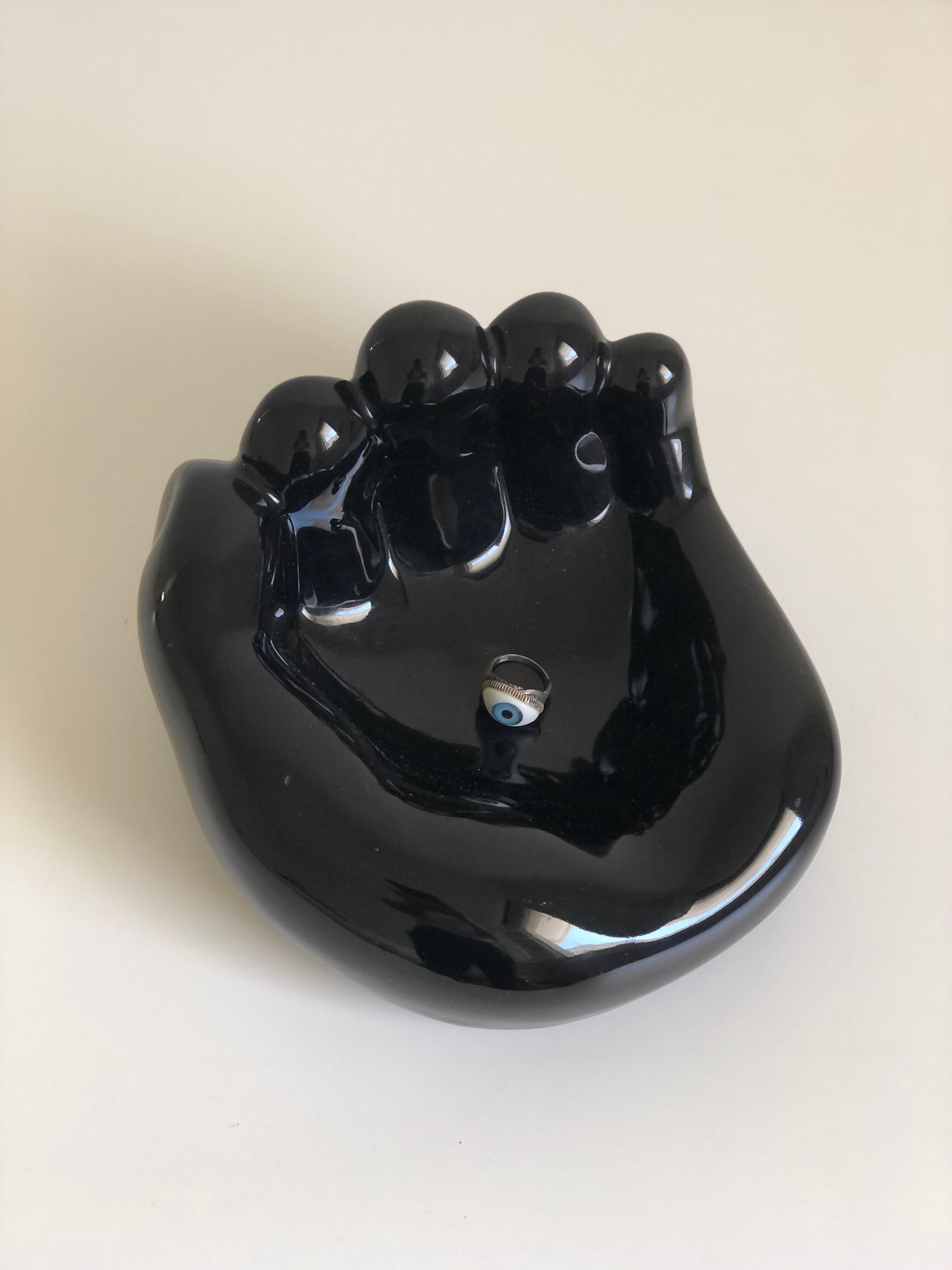 Empty black enamelled hand-shaped ceramic pocket, 1970