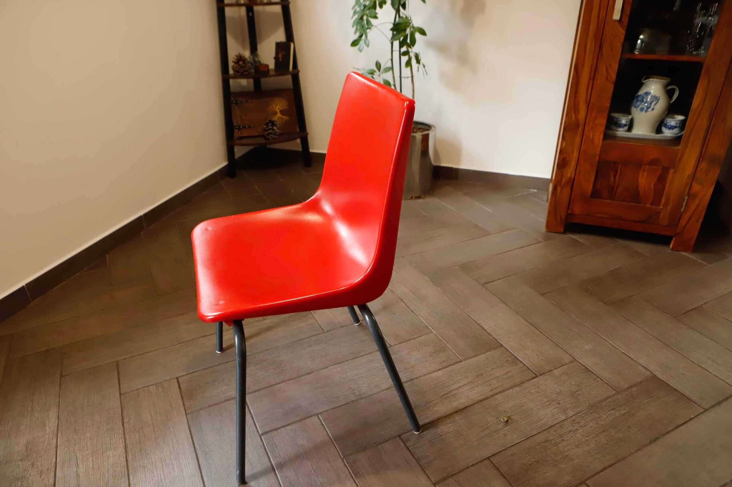 Pair of red plastic chairs with metal frame